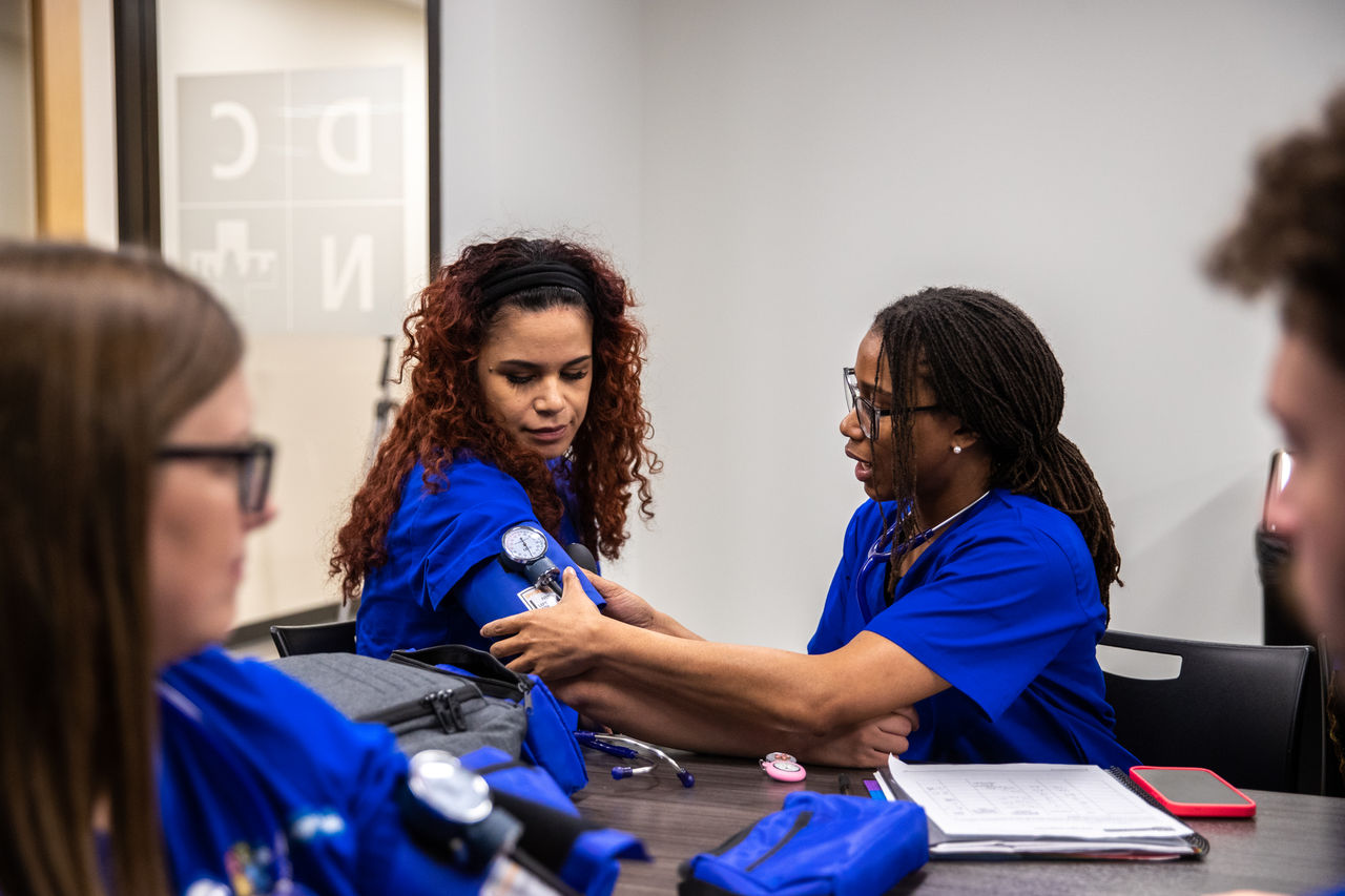 Nursing students practice blood pressure measurement skills