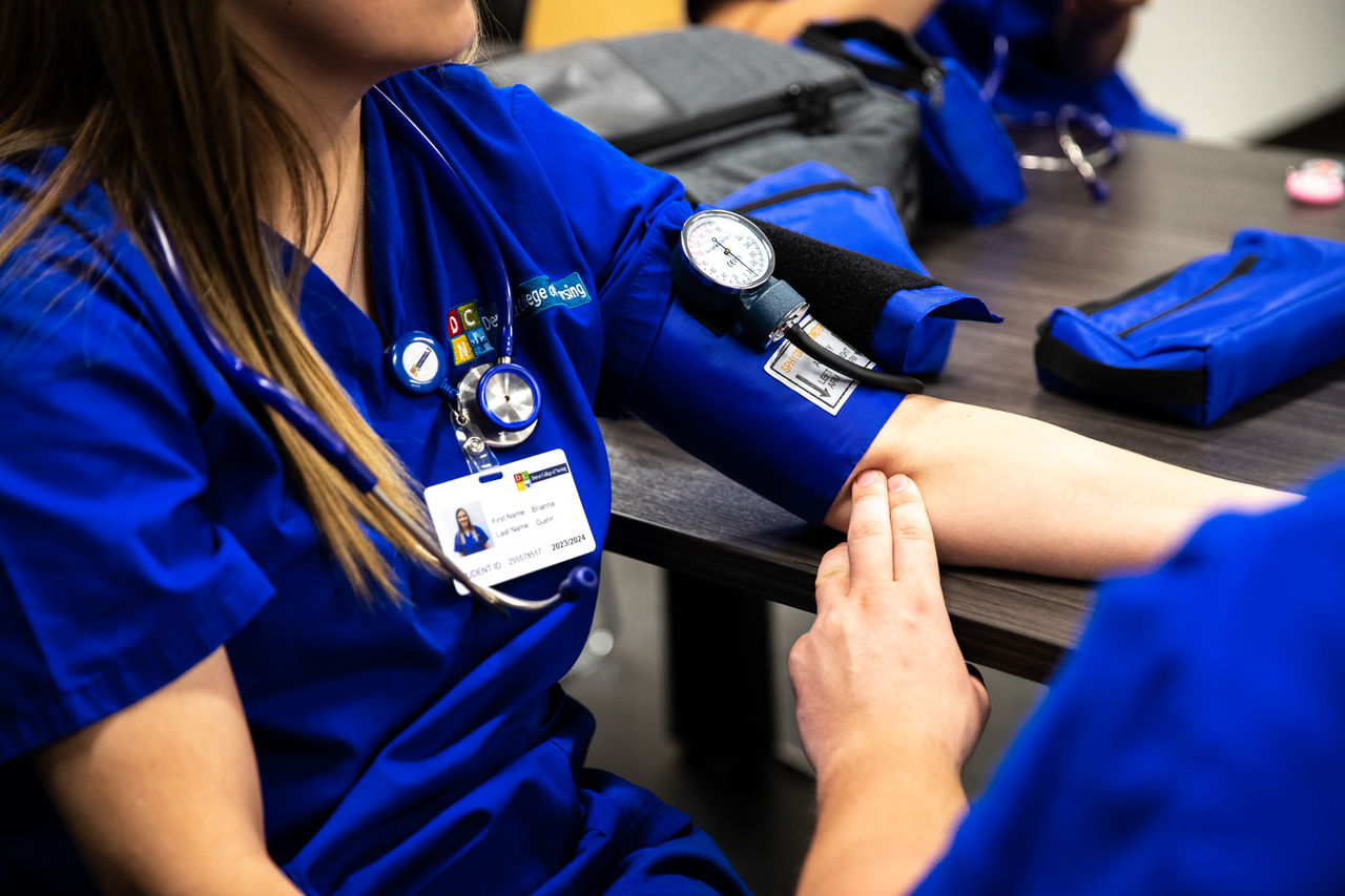 Nursing student practices blood pressure measurement skills