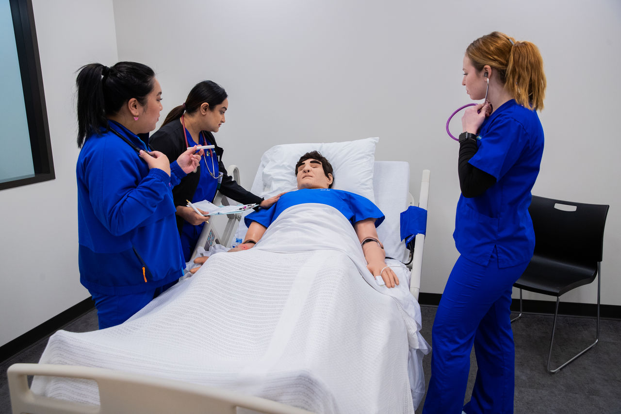 Medical team examines patient in hospital room